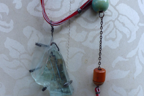 red suede chain, baubles to front Looking glass mannequin bust steel wire red suede necklace