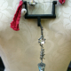 Recycled sewing machine part with hanging charm necklace