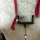 Recycled sewing machine part with hanging charm necklace